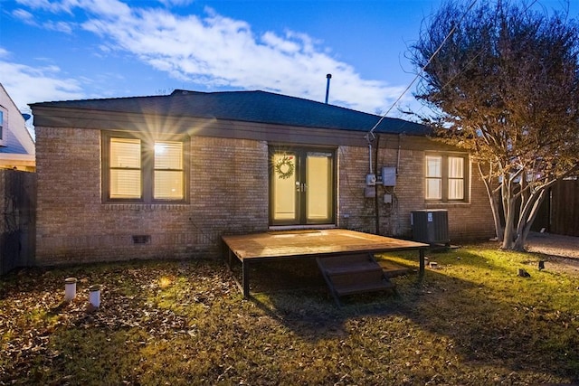 back of property with crawl space, a deck, central AC, and brick siding