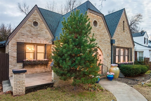 view of front of home with stone siding and a patio