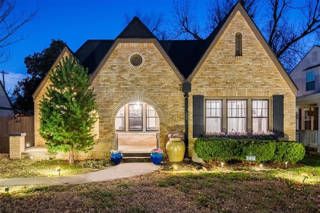 exterior space featuring fence and brick siding