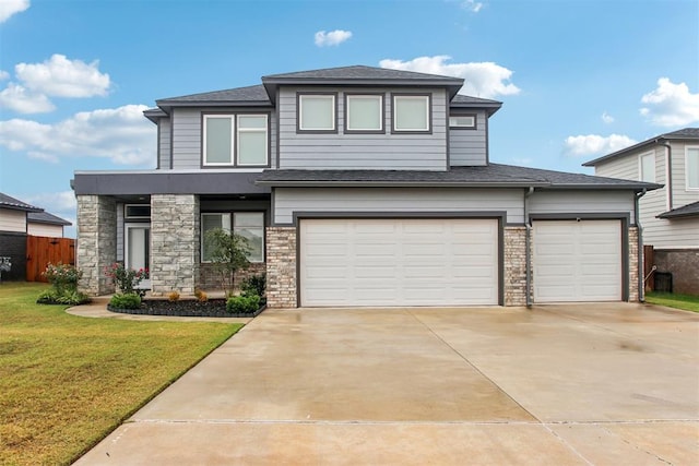 view of front of property with a garage and a front yard