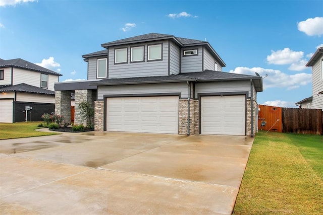 view of front of property featuring a garage and a front lawn