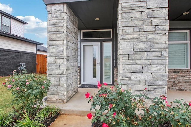 doorway to property with stone siding