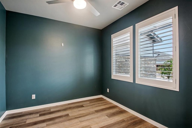 2200 El Cajon St, Edmond, OK 73034 - unfurnished room featuring plenty of natural light, ceiling fan, and wood finished floors