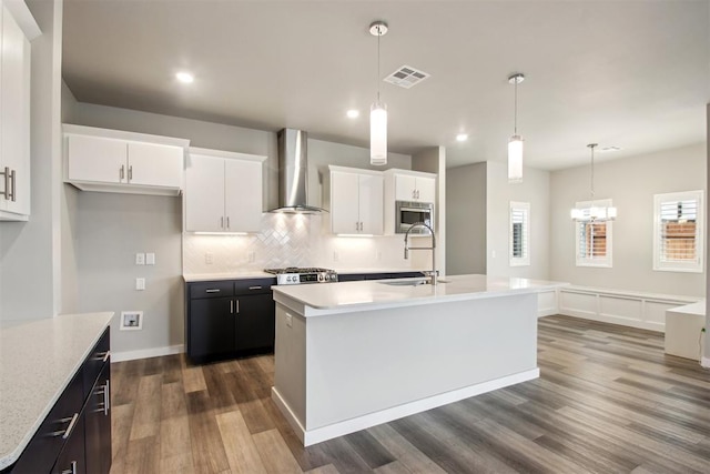 2200 El Cajon St, Edmond, OK 73034 - kitchen featuring wall chimney range hood, stainless steel microwave, dark wood-style floors, white cabinetry, and recessed lighting