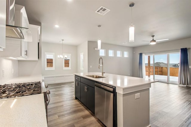2200 El Cajon St, Edmond, OK 73034 - kitchen with appliances with stainless steel finishes, wall chimney exhaust hood, light countertops, light wood-type flooring, and recessed lighting