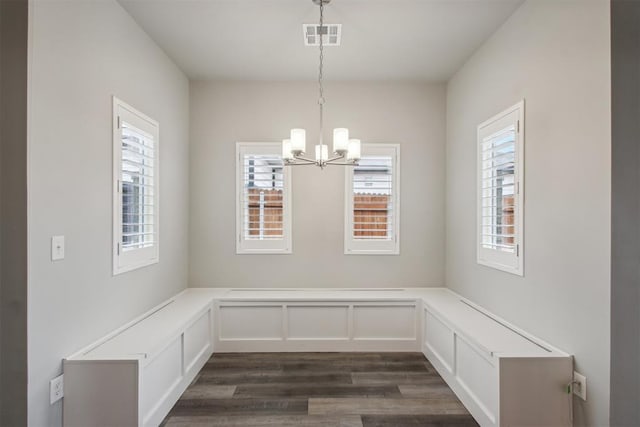 2200 El Cajon St, Edmond, OK 73034 - unfurnished dining area with plenty of natural light, a chandelier, dark wood finished floors, and wainscoting