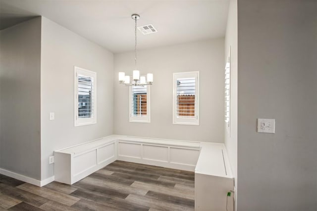 2200 El Cajon St, Edmond, OK 73034 - unfurnished dining area with healthy amount of natural light, a chandelier, and dark wood-type flooring