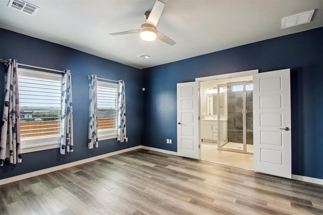 2200 El Cajon St, Edmond, OK 73034 - unfurnished bedroom with wood finished floors, ensuite bathroom, and ceiling fan