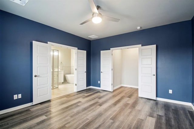 2200 El Cajon St, Edmond, OK 73034 - unfurnished bedroom featuring wood finished floors, ensuite bath, and a ceiling fan