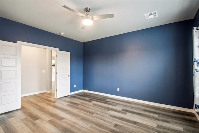 2200 El Cajon St, Edmond, OK 73034 - unfurnished bedroom with wood finished floors and ceiling fan