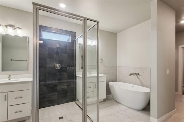 2200 El Cajon St, Edmond, OK 73034 - bathroom featuring marble look tiles, vanity, a stall shower, and a freestanding bath