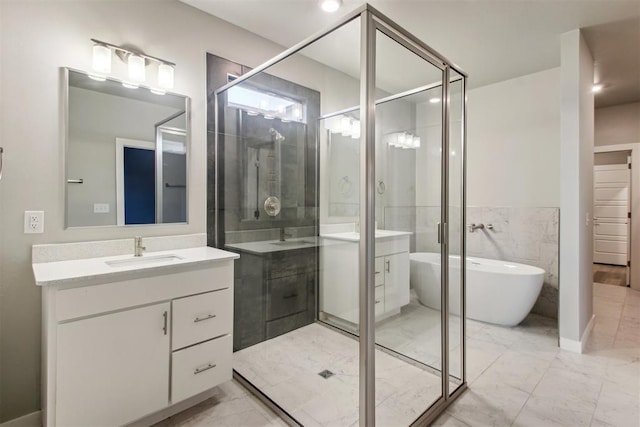2200 El Cajon St, Edmond, OK 73034 - bathroom with vanity, marble look tile flooring, a soaking tub, and a shower stall