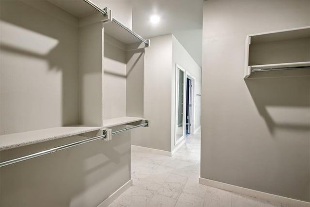 2200 El Cajon St, Edmond, OK 73034 - walk in closet featuring light marble finish flooring