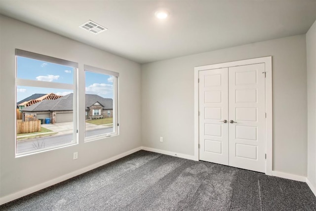 2200 El Cajon St, Edmond, OK 73034 - unfurnished bedroom featuring dark carpet and a closet