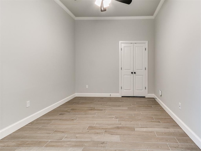 spare room with ceiling fan and crown molding