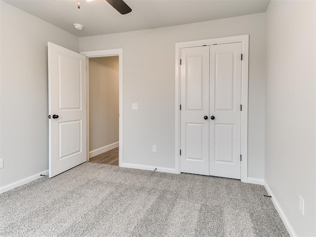 unfurnished bedroom featuring light carpet, a closet, and ceiling fan