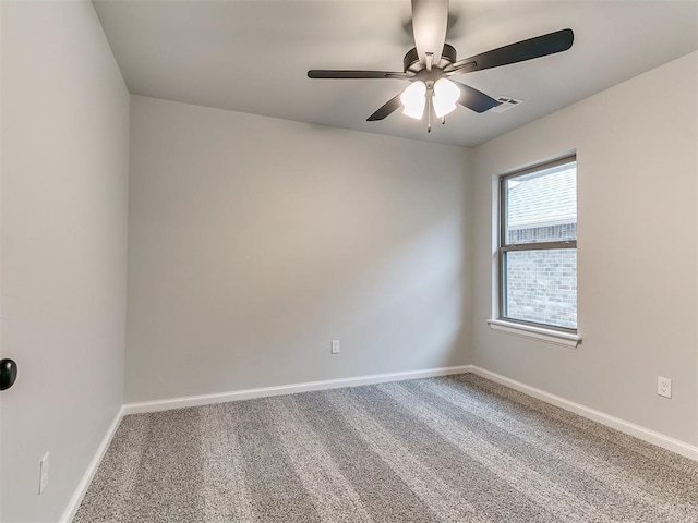 spare room with ceiling fan and carpet floors