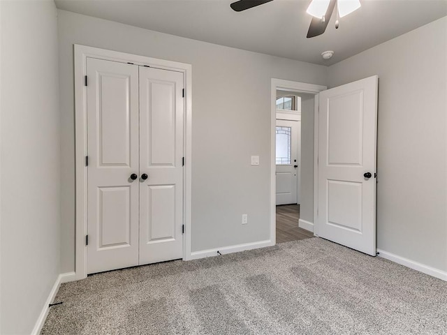 unfurnished bedroom with ceiling fan, a closet, and carpet