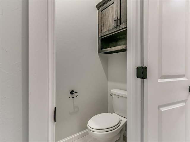 bathroom featuring tile patterned flooring and toilet