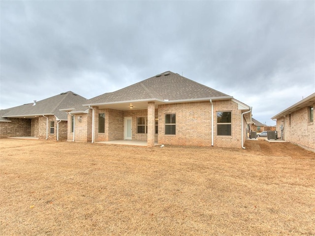 rear view of house with central AC unit and a patio area