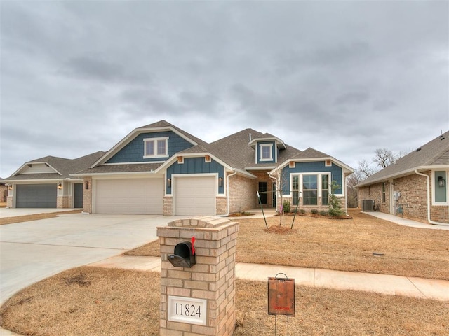 craftsman-style house with a garage and central AC unit