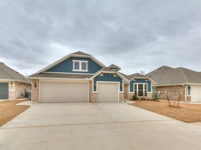 view of front of property featuring central AC and a garage