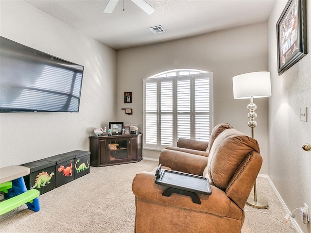 interior space with light carpet and ceiling fan