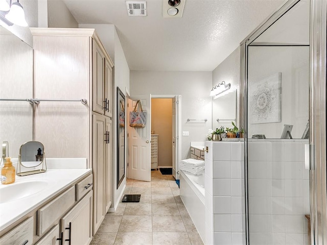 bathroom with vanity, tile patterned floors, and shower with separate bathtub