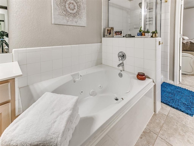 bathroom with vanity, tile patterned flooring, and a bathtub