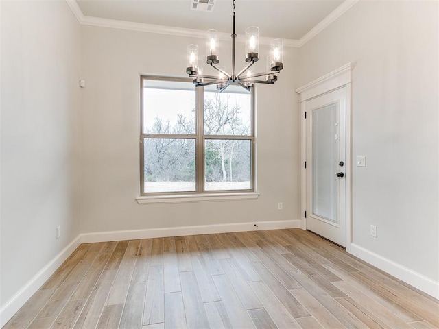 unfurnished dining area with crown molding, a chandelier, and light wood-type flooring