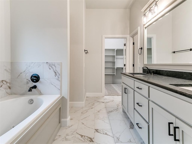 bathroom with vanity and a washtub