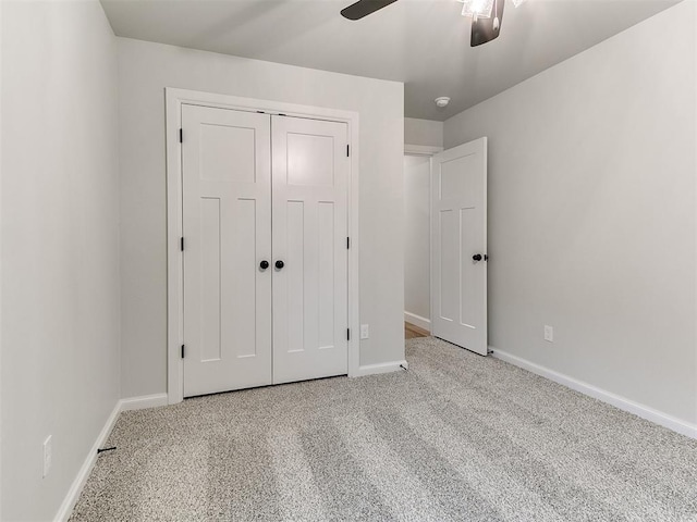 unfurnished bedroom with ceiling fan, a closet, and light carpet