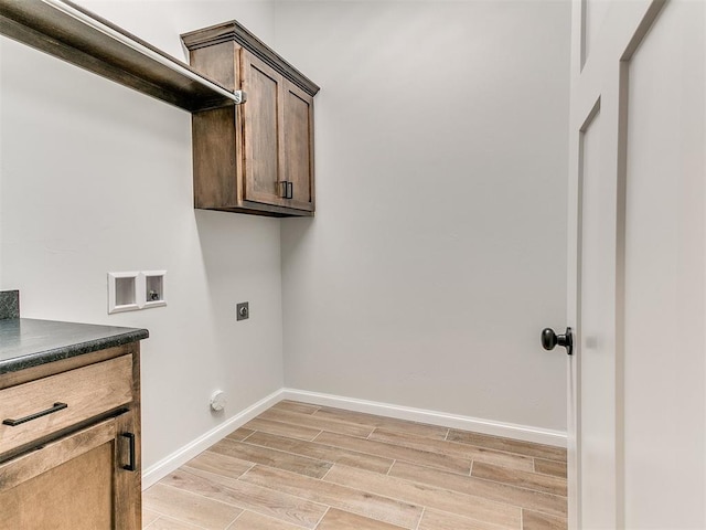 laundry area with hookup for an electric dryer, cabinets, and washer hookup