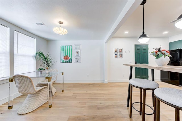 dining space with light hardwood / wood-style flooring