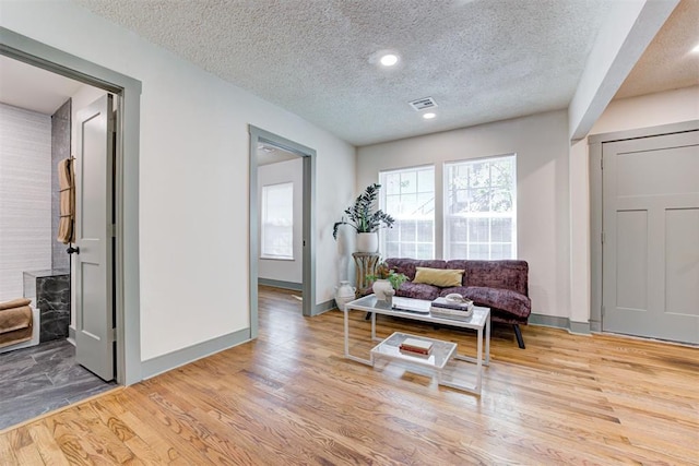 sitting room featuring hardwood / wood-style flooring and a textured ceiling