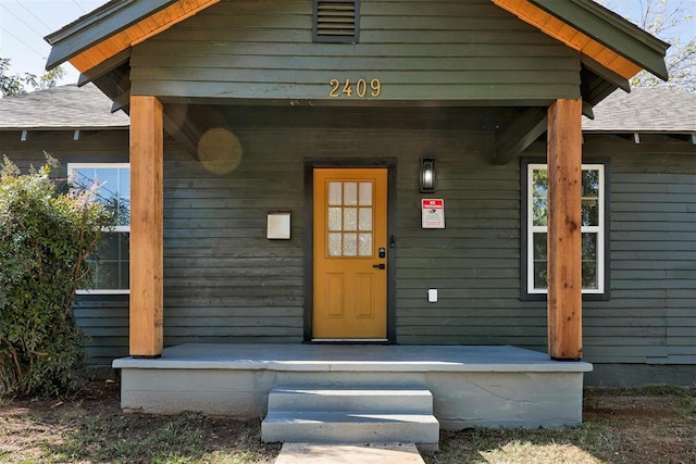 view of exterior entry featuring a porch