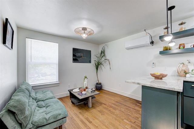 living area with a wall mounted AC and light hardwood / wood-style flooring