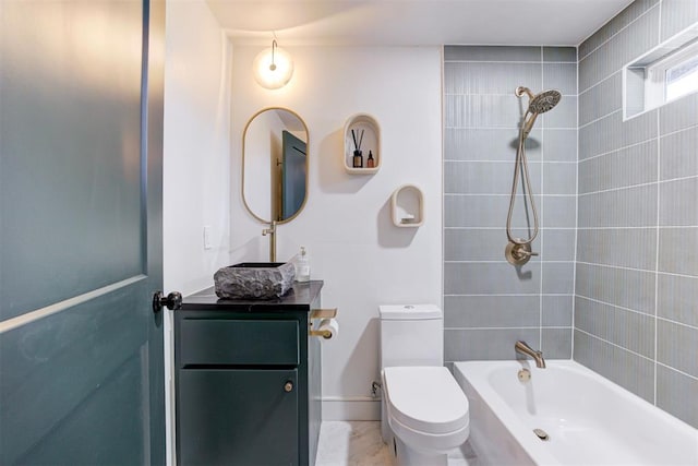 full bathroom with vanity, tiled shower / bath combo, and toilet