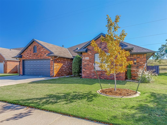 view of front of property with a front yard and a garage