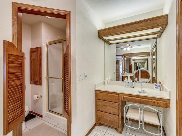 bathroom with ceiling fan, tile patterned flooring, vanity, and a shower with door