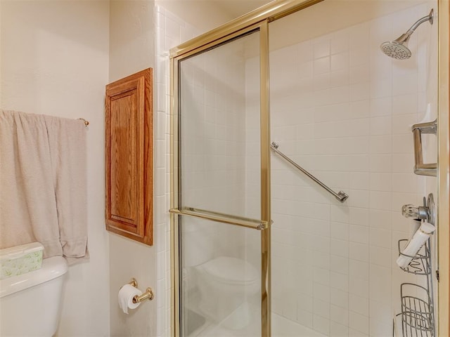 bathroom with toilet and walk in shower