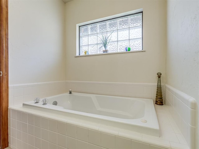 bathroom with tiled bath