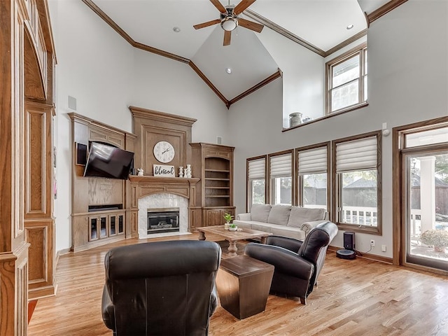 living room featuring light hardwood / wood-style floors, plenty of natural light, and crown molding