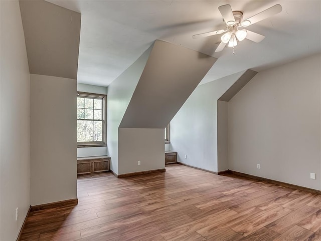 bonus room with light wood-type flooring, ceiling fan, and lofted ceiling