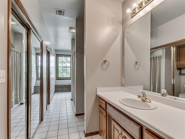 bathroom with tile patterned floors, vanity, and toilet