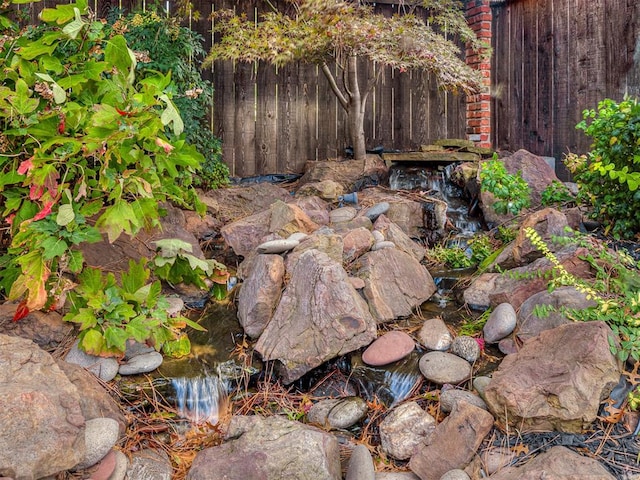 view of yard with a garden pond