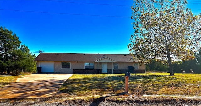 ranch-style home featuring a front yard and a garage