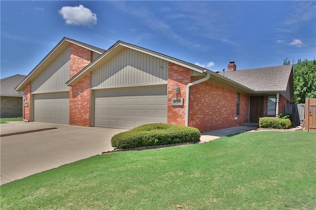 view of front of house featuring a garage and a front lawn