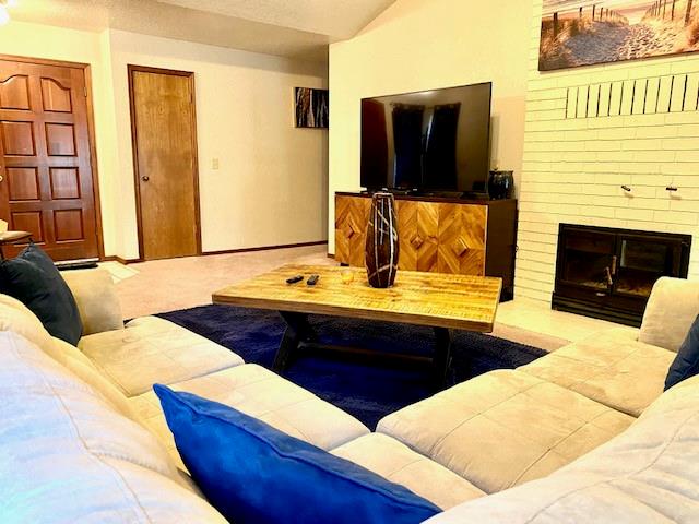 living room featuring a brick fireplace