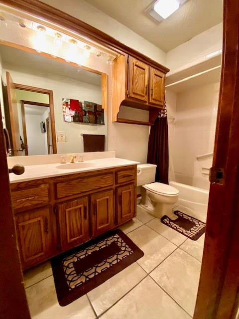 full bathroom with tile patterned flooring, vanity, toilet, and shower / bathtub combination with curtain